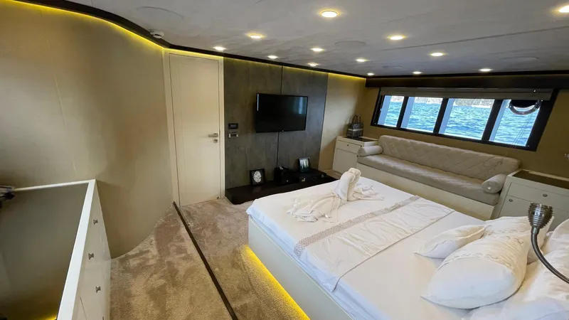 Tmr Yacht Photos Pics Luxurious yacht bedroom with modern decor, large windows, and ambient lighting, Custom 84 model, 2018.