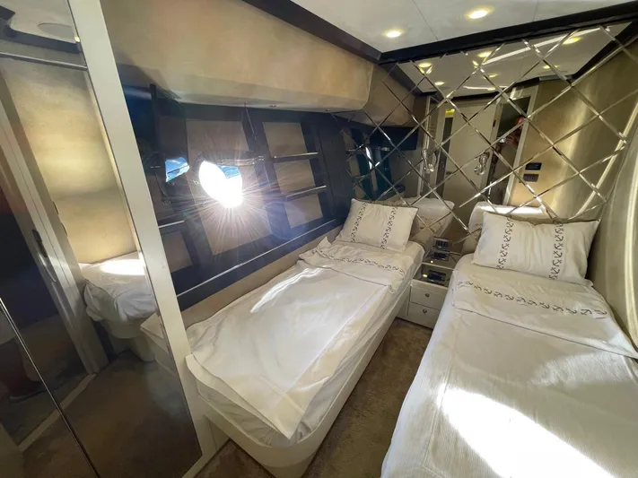 Tmr Yacht Photos Pics Luxurious yacht bedroom with twin beds, mirrored wall, and elegant decor, Custom 84 model, 2018.