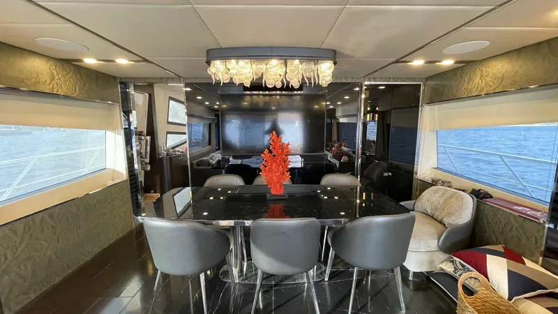 Tmr Yacht Photos Pics Luxurious yacht interior with modern dining area, elegant chandelier, and ocean view windows.
