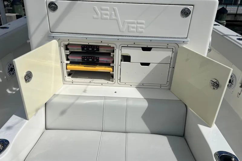  Yacht Photos Pics 2015 SeaVee 390Z boat storage compartment with open doors and organized tackle boxes.
