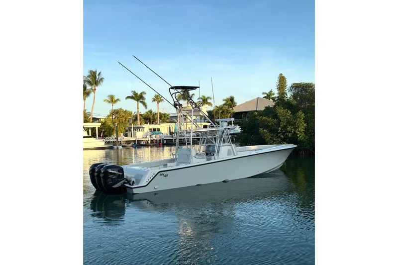  Yacht Photos Pics 2015 SeaVee 390Z boat with triple Mercury engines on calm water, surrounded by palm trees.