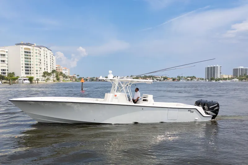  Yacht Photos Pics 2015 SeaVee 39Z boat cruising on a sunny waterfront with modern buildings.