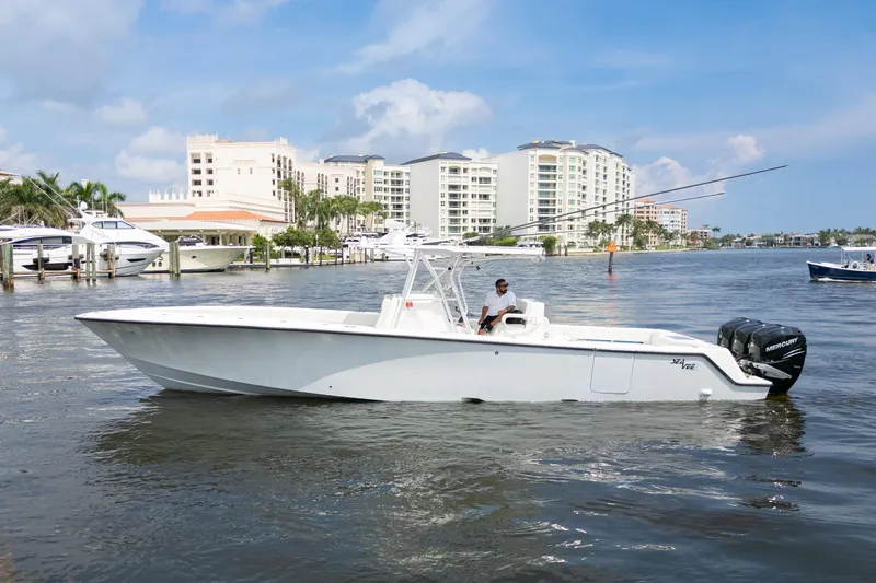  Yacht Photos Pics 2015 SeaVee 39Z boat on water near marina with buildings in background.