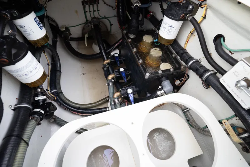  Yacht Photos Pics Engine compartment of a 2015 SeaVee 39Z boat, showcasing filters and hoses.