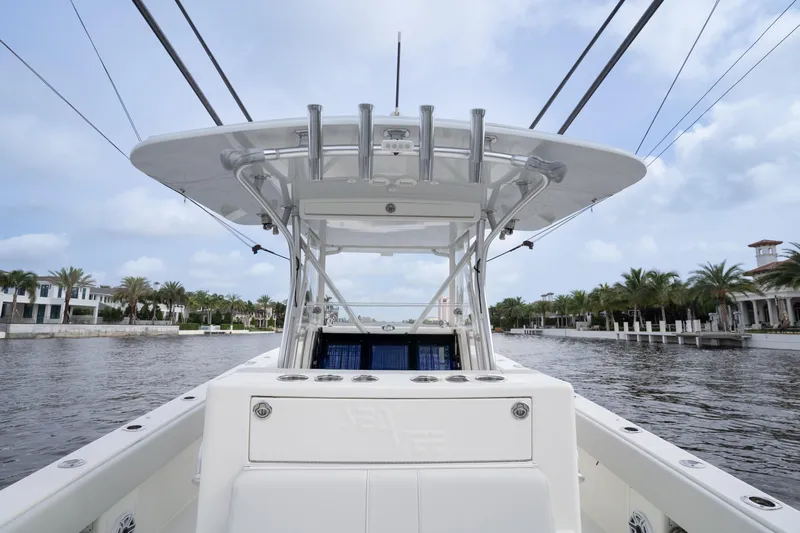  Yacht Photos Pics 2015 SeaVee 39Z boat on a calm waterway, surrounded by palm trees and luxury homes.
