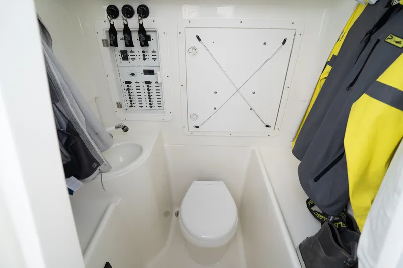  Yacht Photos Pics 2015 SeaVee 39Z boat interior with toilet, control panel, and hanging jackets.