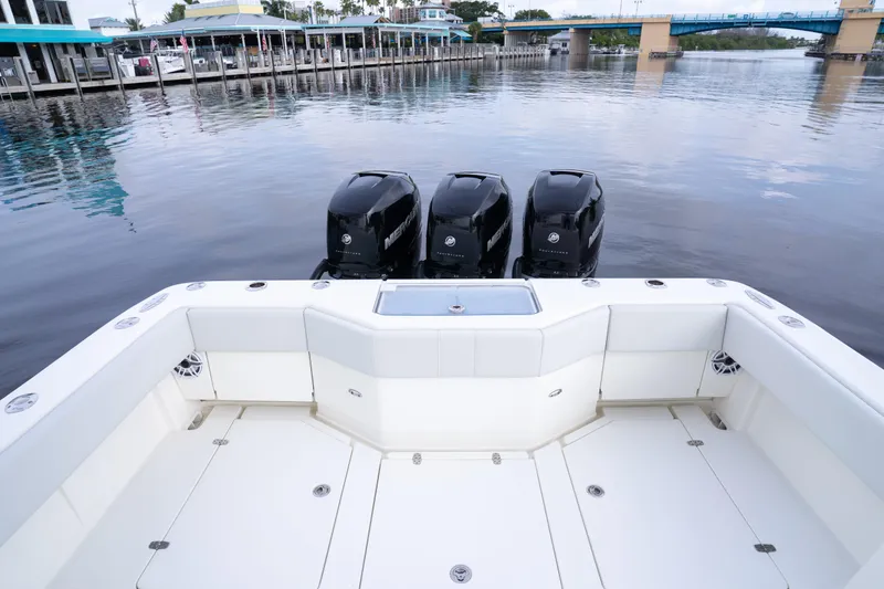  Yacht Photos Pics 2015 SeaVee 39Z boat with triple Mercury engines, docked near a waterfront.