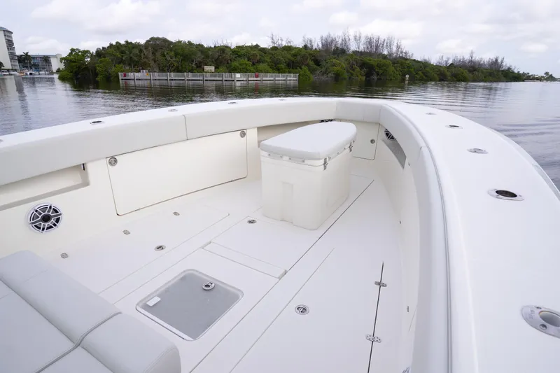  Yacht Photos Pics 2015 SeaVee 39Z boat interior with seating and storage, docked near lush greenery.