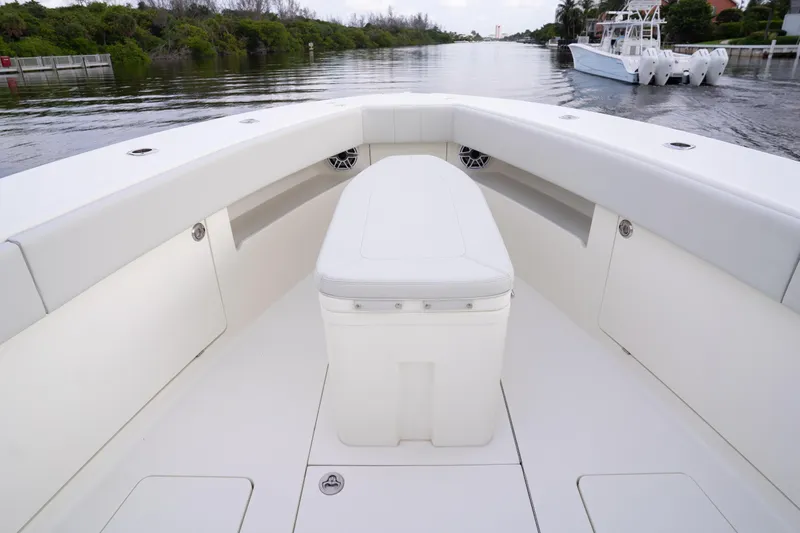  Yacht Photos Pics 2015 SeaVee 39Z boat interior with white seating and storage, docked on a calm waterway.