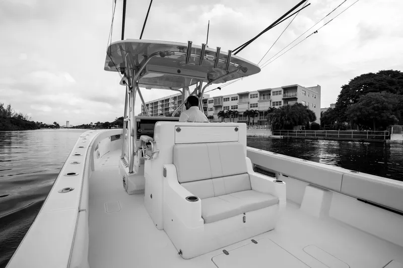  Yacht Photos Pics 2015 SeaVee 39Z boat cruising on a calm waterway, with modern buildings in the background.