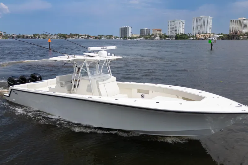  Yacht Photos Pics 2015 SeaVee 39Z boat cruising on water with city skyline in background.
