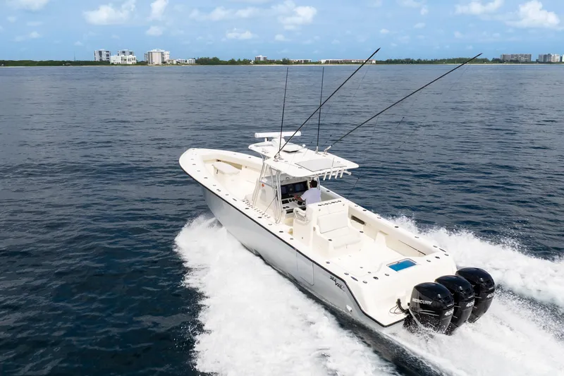  Yacht Photos Pics 2015 SeaVee 39Z boat cruising on open water with triple Mercury engines.