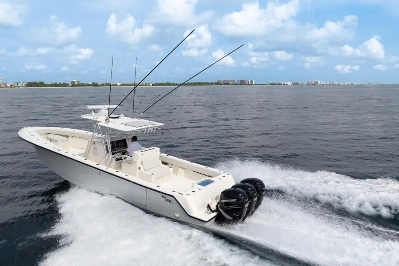  Yacht Photos Pics 2015 SeaVee 39Z boat cruising on open water with triple Mercury engines.