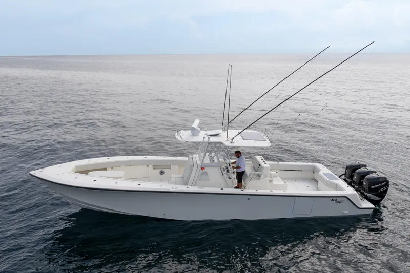  Yacht Photos Pics 2015 SeaVee 39Z boat on open water, equipped with fishing rods and outboard motors.
