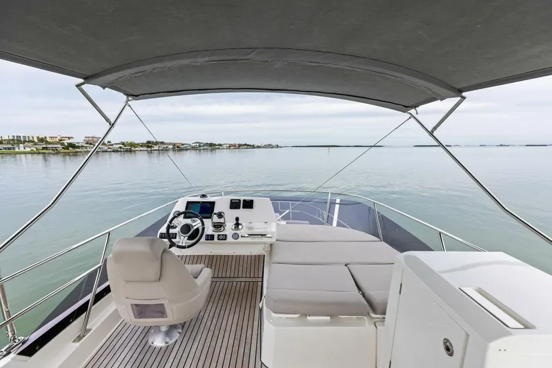 So Fly Yacht Photos Pics 2022 Prestige 420 yacht helm with serene waterfront view.