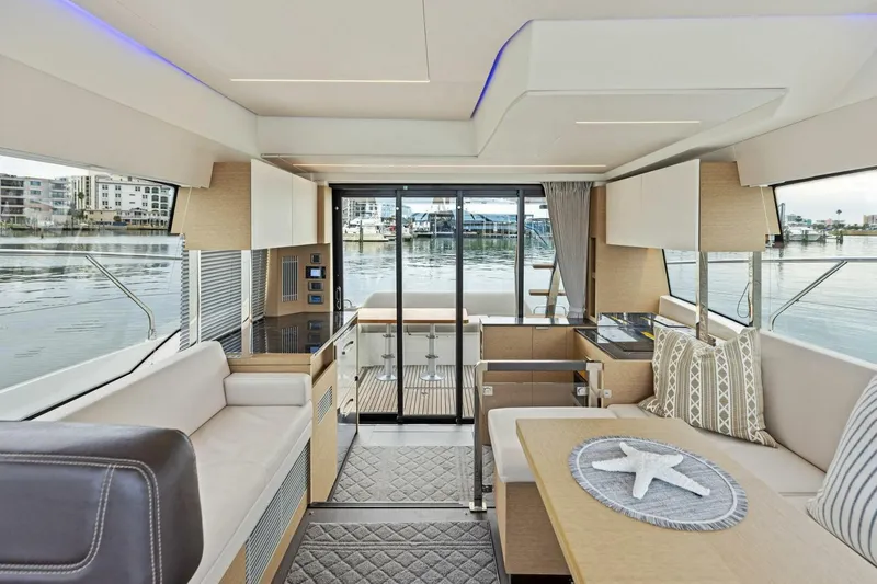 So Fly Yacht Photos Pics Luxurious interior of 2022 Prestige 420 yacht with modern furnishings and waterfront view.