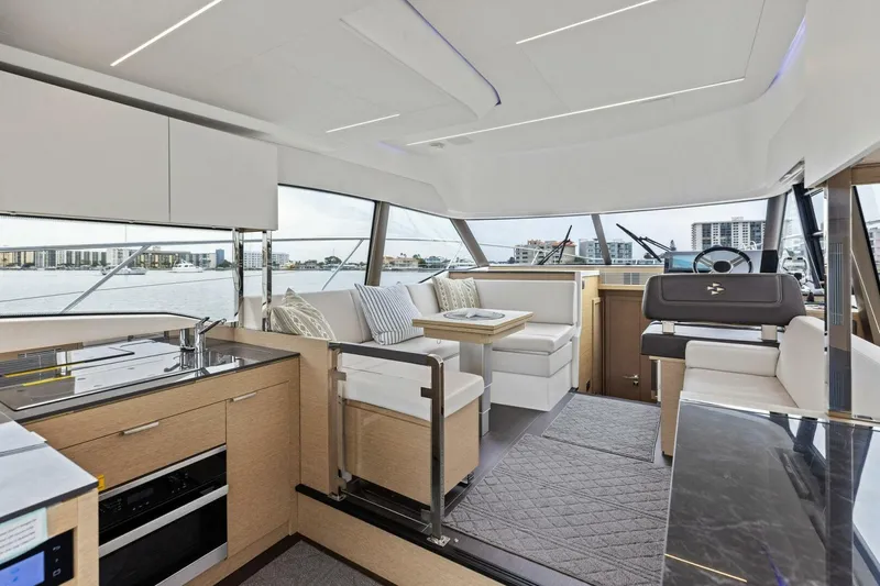 So Fly Yacht Photos Pics Luxurious interior of 2022 Prestige 420 yacht with modern kitchen and seating area.