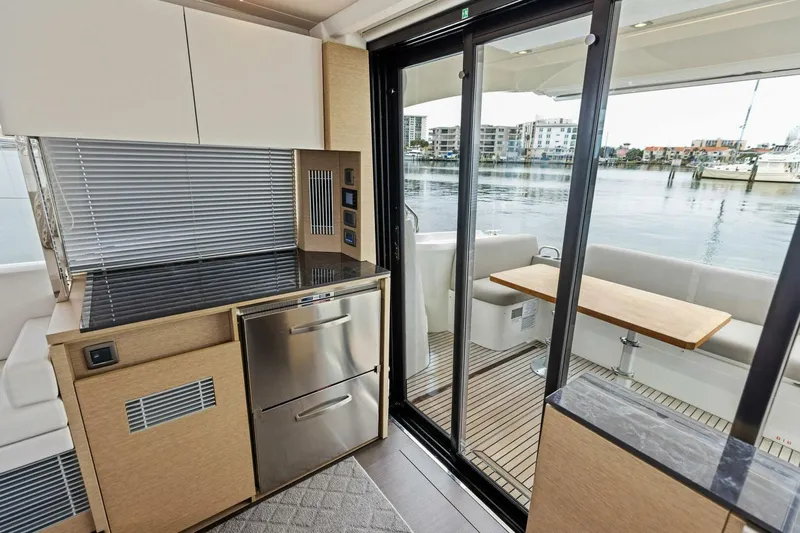 So Fly Yacht Photos Pics Modern kitchen and dining area on 2022 Prestige 420 yacht with waterfront view.