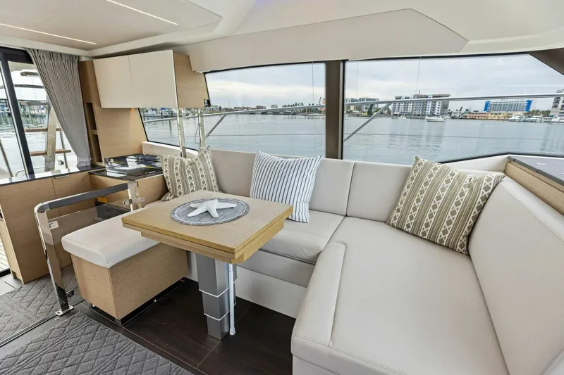 So Fly Yacht Photos Pics Luxurious interior of 2022 Prestige 420 yacht with elegant seating and waterfront view.