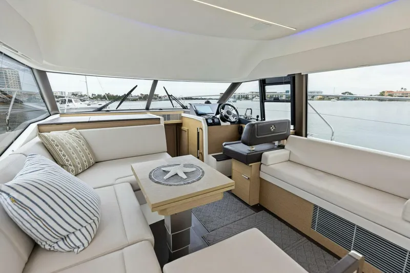 So Fly Yacht Photos Pics Luxurious interior of 2022 Prestige 420 yacht with elegant seating and helm view.