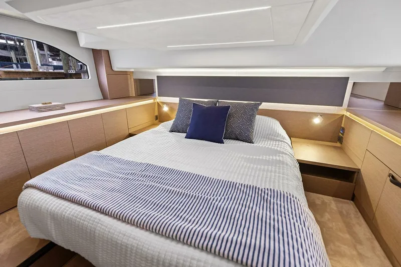 So Fly Yacht Photos Pics Luxurious cabin interior of 2022 Prestige 420 yacht with modern bedding and ambient lighting.