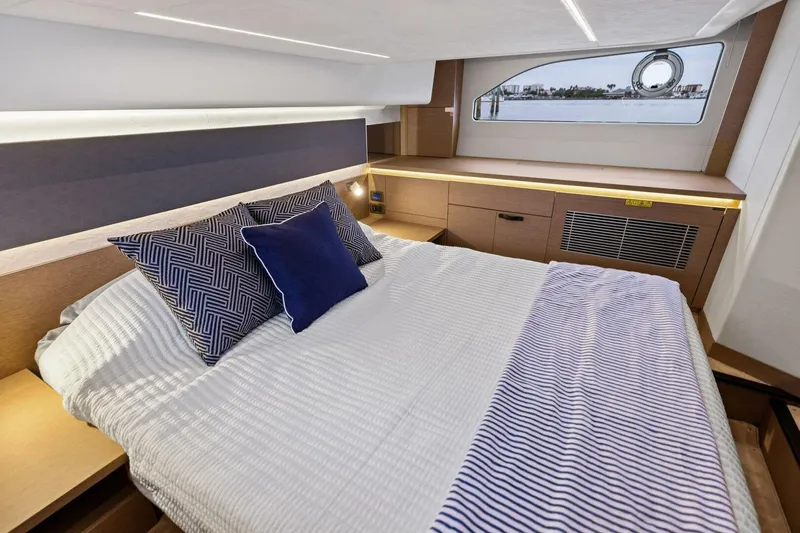 So Fly Yacht Photos Pics Luxurious bedroom interior of 2022 Prestige 420 yacht with modern design and window view.