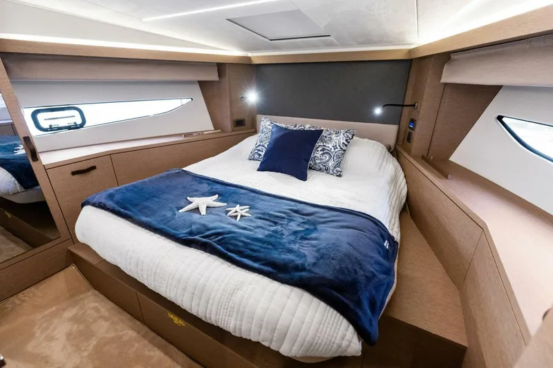 So Fly Yacht Photos Pics Luxurious cabin interior of 2022 Prestige 420 yacht with cozy bedding and elegant design.