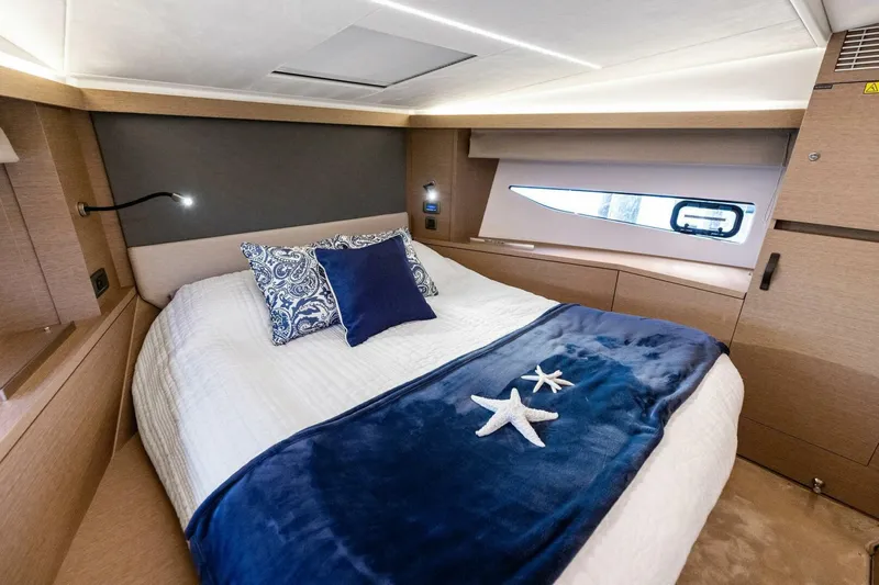 So Fly Yacht Photos Pics Luxurious cabin interior of 2022 Prestige 420 yacht with elegant bedding and modern design.