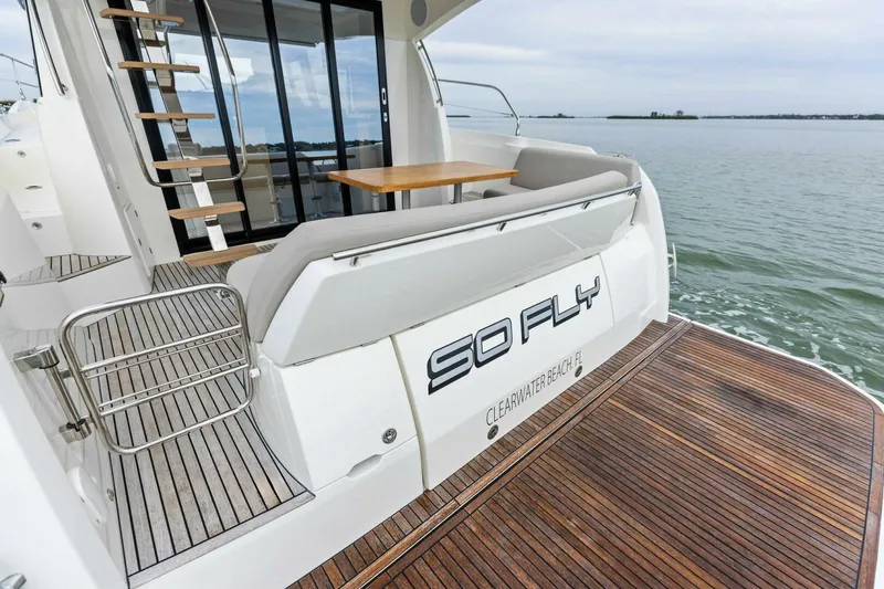 So Fly Yacht Photos Pics Luxury 2022 Prestige 420 yacht with wooden deck, docked at sea.