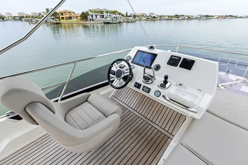 So Fly Yacht Photos Pics Luxury yacht helm with modern controls, Prestige 420, 2022 model, overlooking serene waterfront.