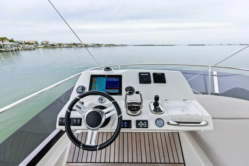So Fly Yacht Photos Pics Helm of 2022 Prestige 420 yacht with modern navigation controls and serene water view.