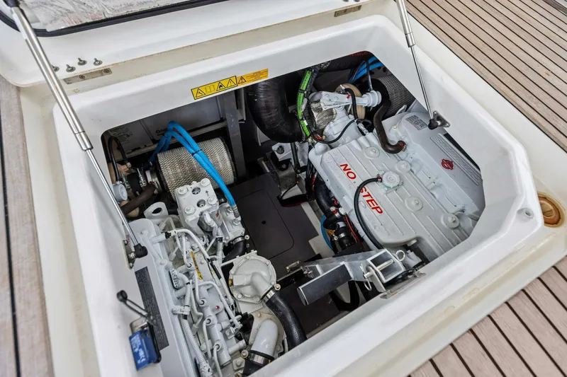 So Fly Yacht Photos Pics Engine compartment of 2022 Prestige 420 yacht, showcasing mechanical components and "No Step" warning.