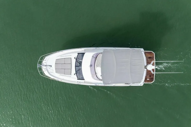 So Fly Yacht Photos Pics Aerial view of 2022 Prestige 420 yacht cruising on green water.