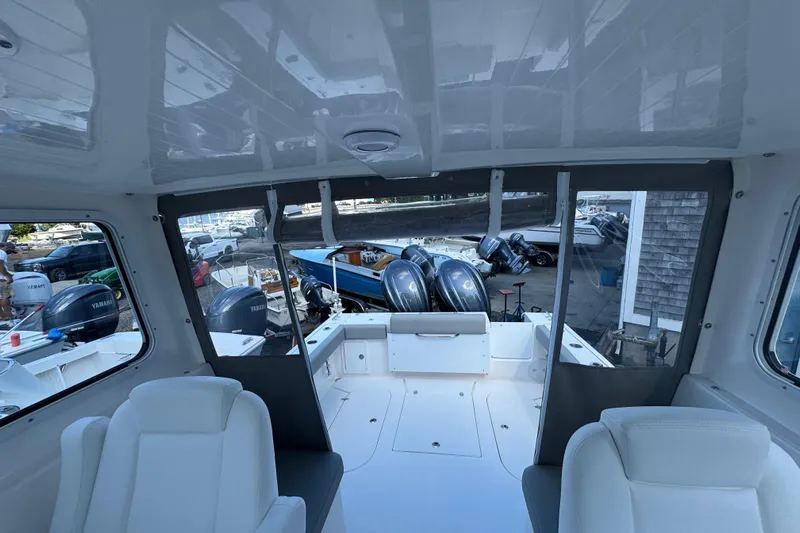  Yacht Photos Pics Interior view of 2025 NorthCoast 255 HT boat with Yamaha engines in marina.