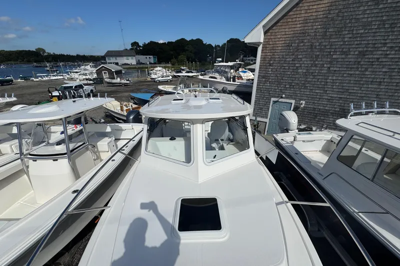  Yacht Photos Pics 2025 NorthCoast 255 HT boat docked among other vessels at a marina.