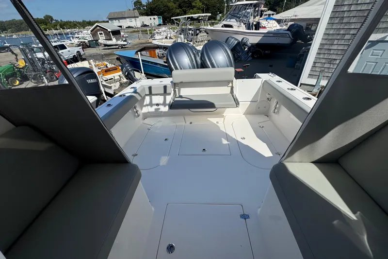  Yacht Photos Pics 2025 NorthCoast 255 HT boat interior with seating and storage, docked at a marina.