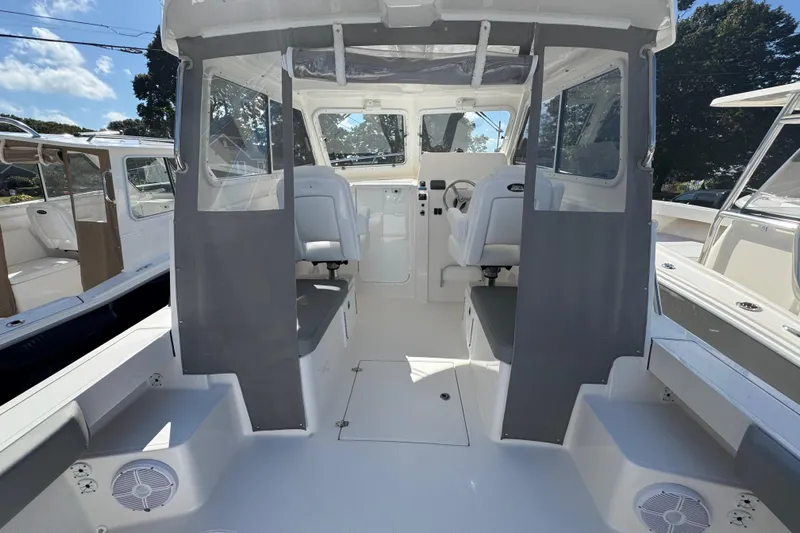 Yacht Photos Pics 2025 NorthCoast 255 HT boat interior with helm, seating, and clear canopy.
