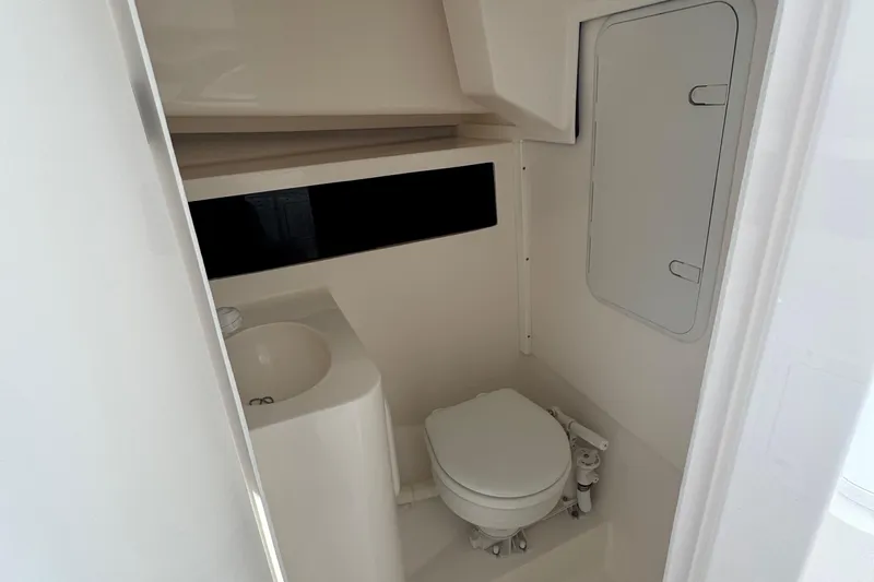  Yacht Photos Pics 2025 NorthCoast 255 HT boat bathroom with compact toilet and sink.
