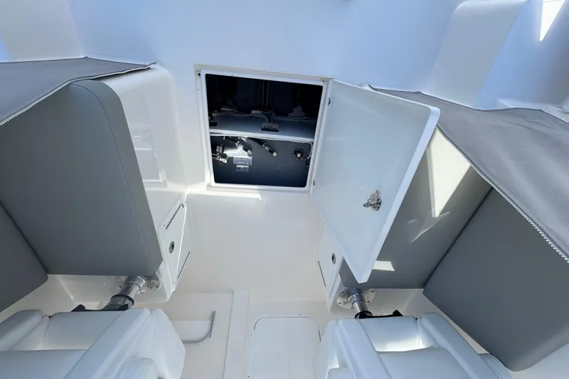  Yacht Photos Pics 2025 NorthCoast 255 HT boat interior with open storage compartment and cushioned seating.