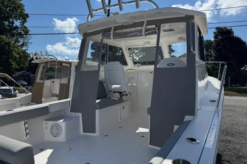  Yacht Photos Pics 2025 NorthCoast 255 HT boat interior with seating and helm, under a clear blue sky.