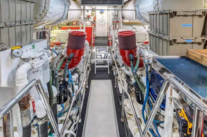 True North Yacht Photos Pics Engine room of 1987 Feadship Full Displacement yacht, featuring red air filters and organized piping.