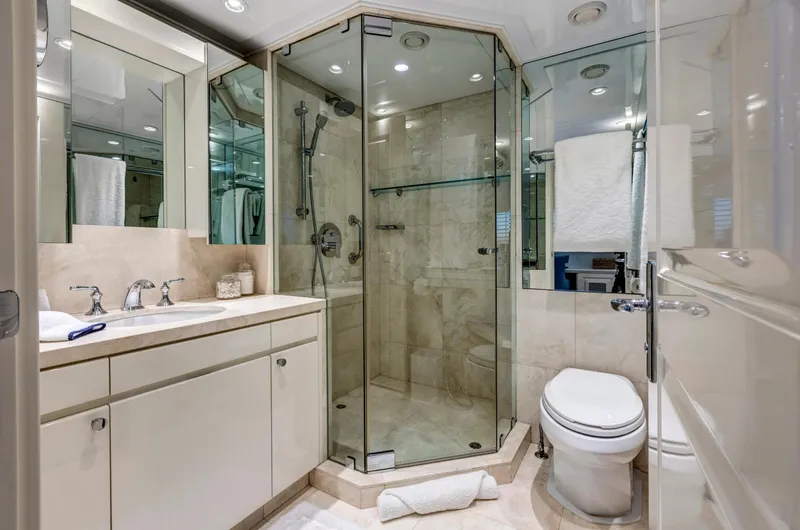 True North Yacht Photos Pics Luxurious yacht bathroom with glass shower, elegant fixtures, and modern design, Feadship 1987 model.