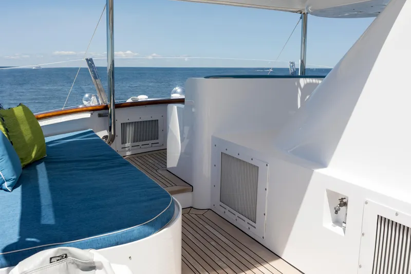 True North Yacht Photos Pics Luxurious 1987 Feadship yacht deck with ocean view and comfortable seating.