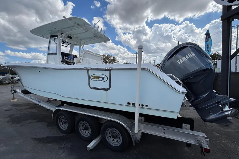  Yacht Photos Pics 2018 Sea Hunt Gamefish 30 boat on trailer with Yamaha engine under cloudy sky.