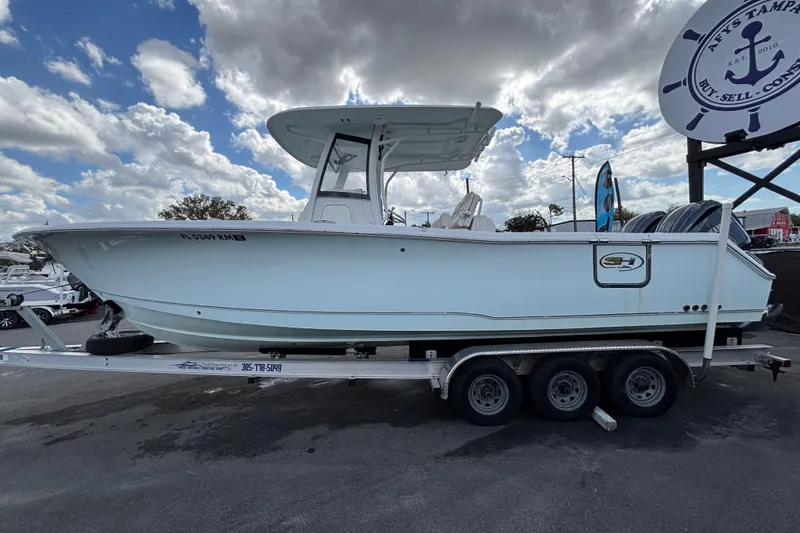  Yacht Photos Pics 2018 Sea Hunt Gamefish 30 boat on trailer under cloudy sky.