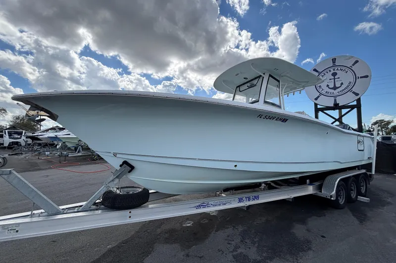  Yacht Photos Pics 2018 Sea Hunt Gamefish 30 boat on trailer under cloudy sky.