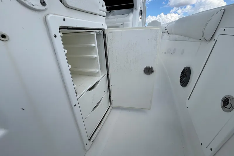 Yacht Photos Pics 2018 Sea Hunt Gamefish 30 Forward Seating storage compartment with open door, showcasing shelves and drawers.
