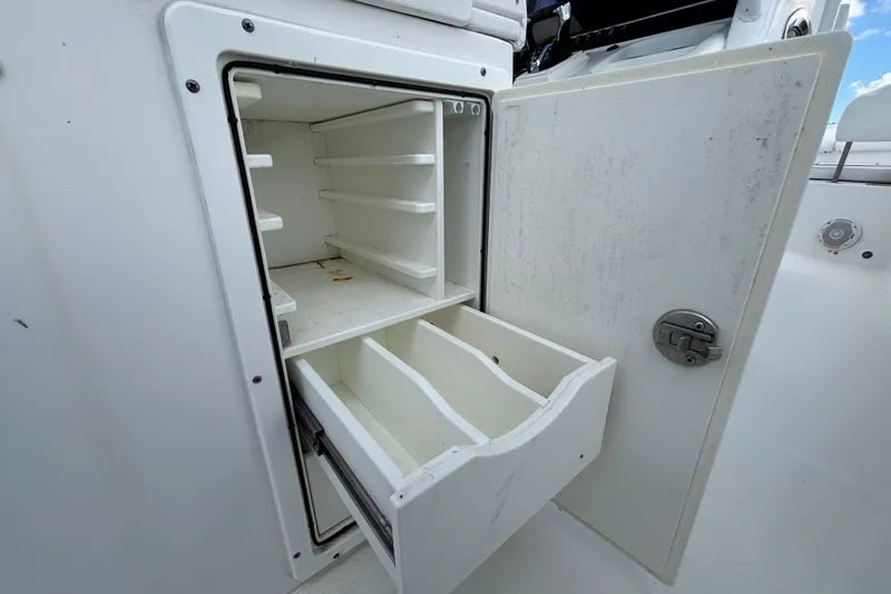  Yacht Photos Pics Open storage compartment on 2018 Sea Hunt Gamefish 30 boat, featuring shelves and drawers.