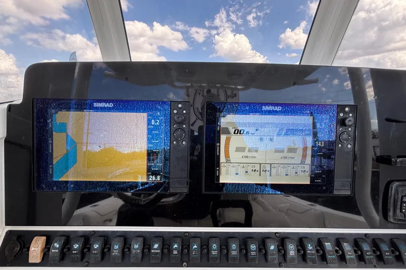  Yacht Photos Pics 2018 Sea Hunt Gamefish 30 dashboard with dual Simrad displays under a cloudy sky.