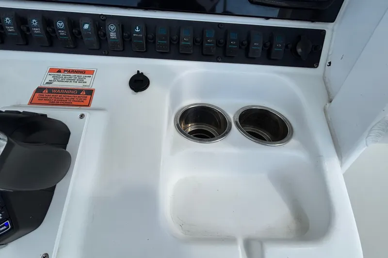  Yacht Photos Pics Control panel of 2018 Sea Hunt Gamefish 30 with cup holders and warning labels.
